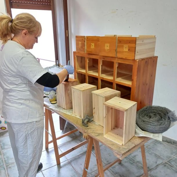 Imagen de una mujer restaurando su propio muebles en clase de restauración